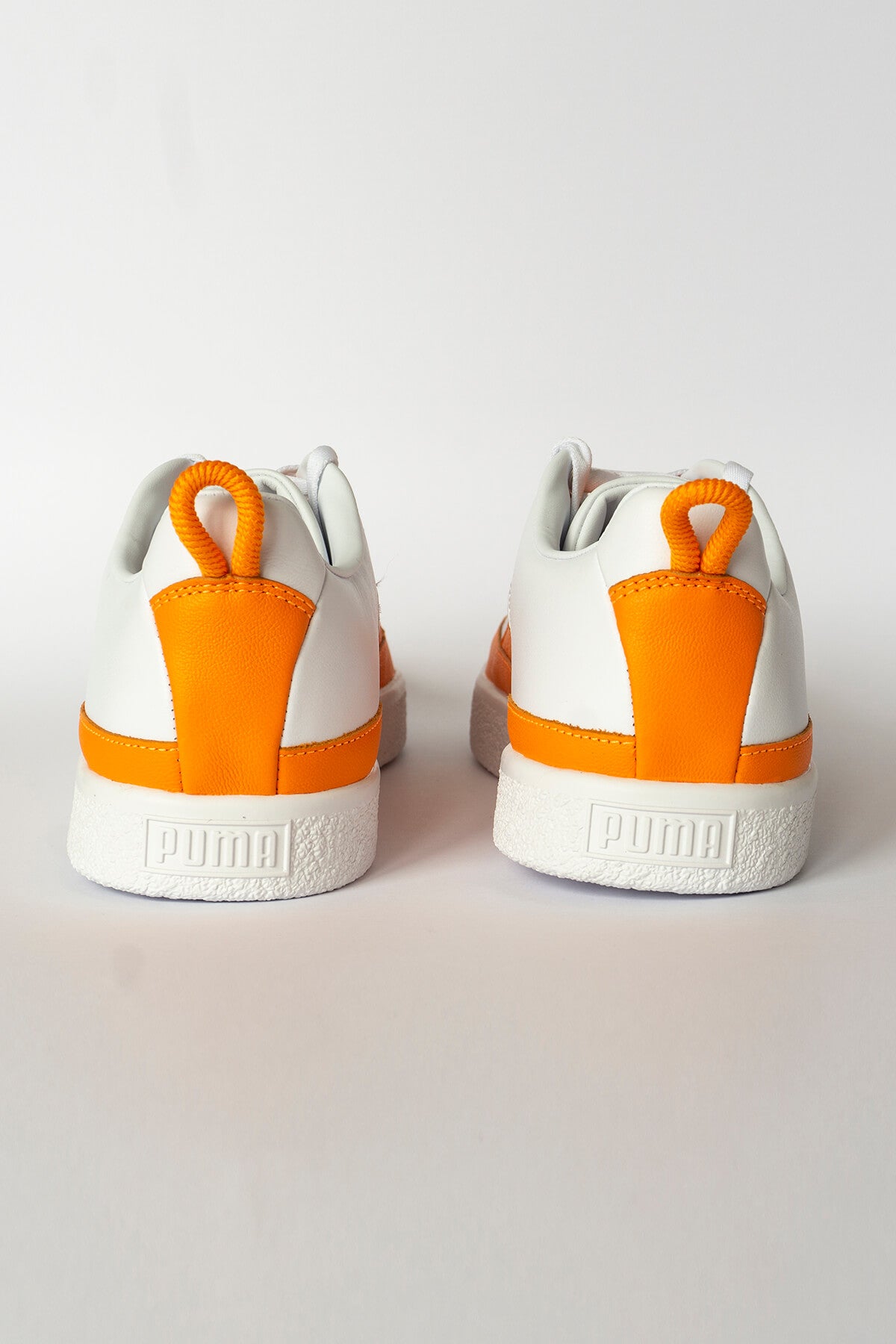 Orange and white store puma